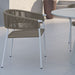 Close Up View Of An Afton Outdoor Dining Chair With Natural Cord And White Frame On a Patio