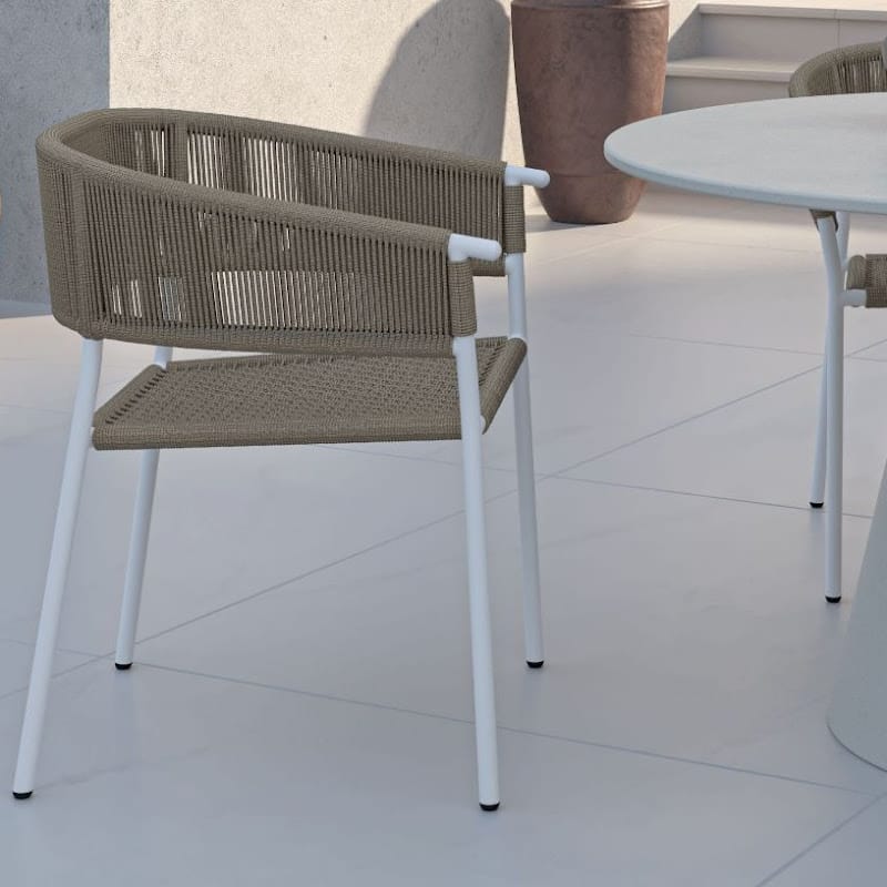 Close Up View Of An Afton Outdoor Dining Chair With Natural Cord And White Frame On a Patio
