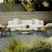 Two Afton Outdoor Lounge Chairs With Palisades Cushion, Natural Cord, And Black Frame Next To a Sofa And Coffee Table