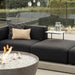 Close Up Of The Arya Outdoor Modular Sectional Sofa In Acadia Color Next To Glass Fence In a Backyard