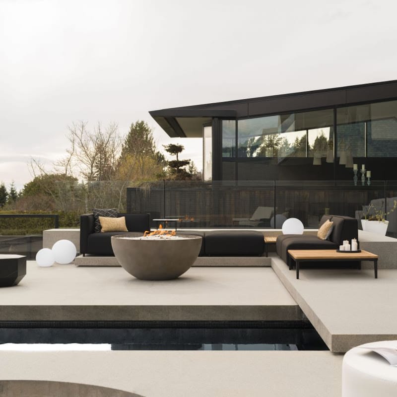 The Arya Outdoor Modular Sectional Sofa In Arcadia Color Behind a House