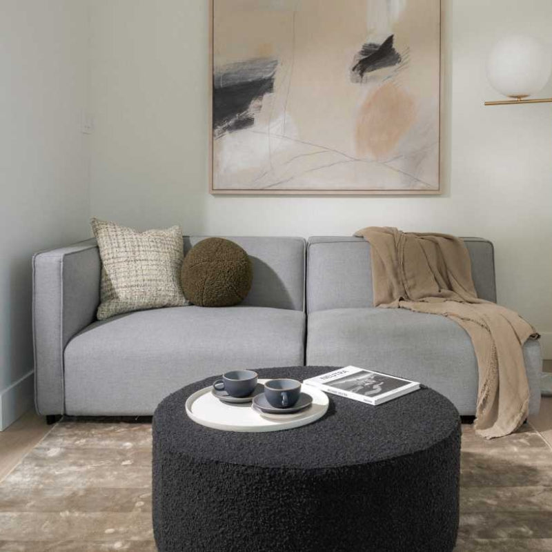 Front Facing View of The Arya Modular Sectional in Porpoise Fabric in a Living Room Against a Wall