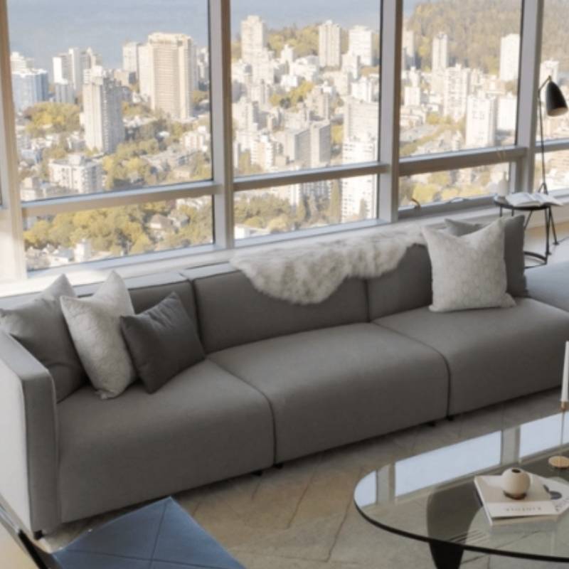 The Arya Modular Sectional in Porpoise Fabric and Color in a Living Room Next to Window