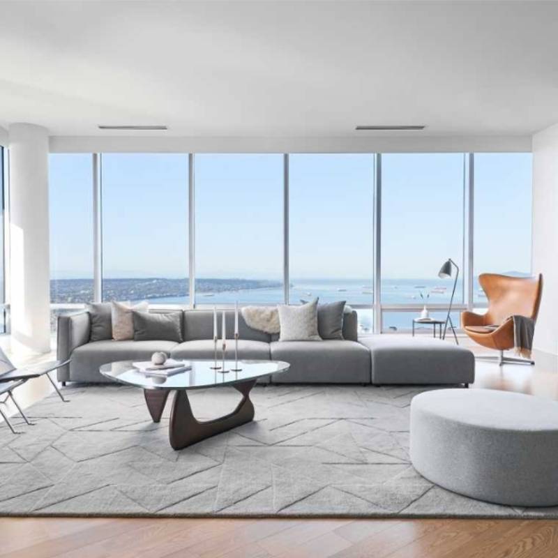 The Arya Modular Sectional in Porpoise Fabric and Color in a Living Room Next to Window