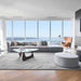 The Arya Modular Sectional in a Living Room Against a Window