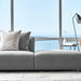 Close Up of An Arya Modular Sectional in Porpoise Fabric in Front of a Living Room Window