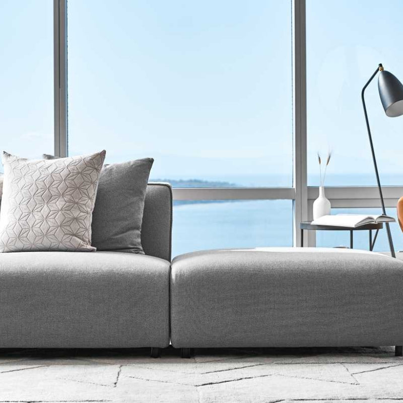 Close Up of An Arya Modular Sectional in Porpoise Fabric in Front of a Living Room Window