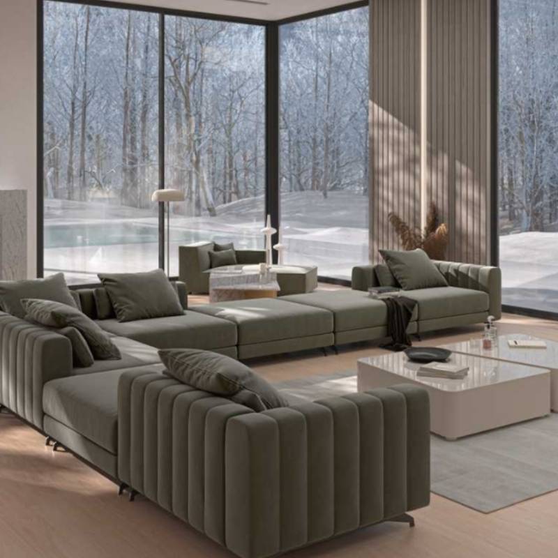Angled Rear Facing of The Berlin Sectional Sofa in Moonstone Color and Fabric in a Living Room With Window in The Background