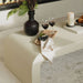 Close Up View of The Cascadia Coffee Table With Alabaster Concrete Surface in a Living Room And Wine Being Served