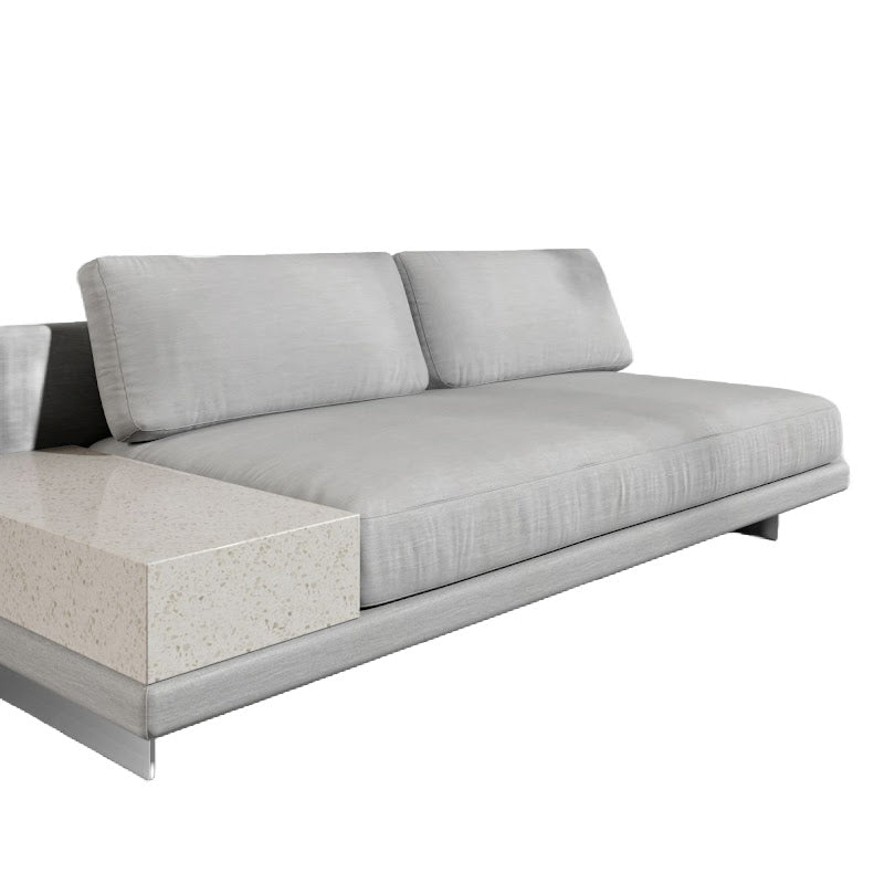Angled View of the Dresden Outdoor Armless Sofa with Side Table in Encino Color and White Terrazzo Table