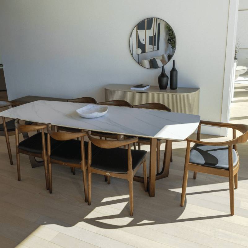 Round Chairs in Black and Wood Finishes at The Head of a Dining Table