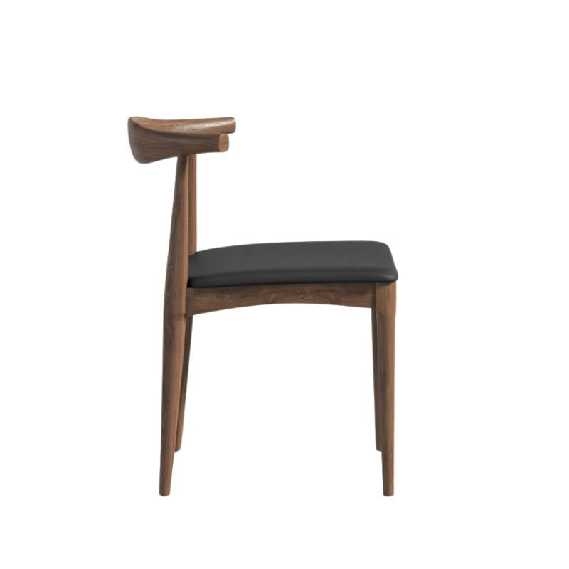 Side Facing View of The Elbow Chair in Trento Jet Black and Wood Finishes