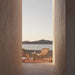 Two Jericho Sling Chairs At The End of and Outdoor Hallway Overlooking the Lake
