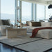 The Romulus Nesting Coffee Table in White Travertine in a Living Room