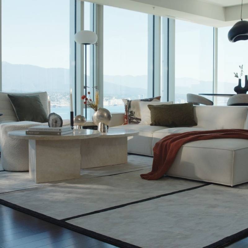 The Romulus Nesting Coffee Table in White Travertine in a Living Room