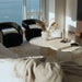 The Romulus Nesting Coffee Table in White Travertine in a Living Room