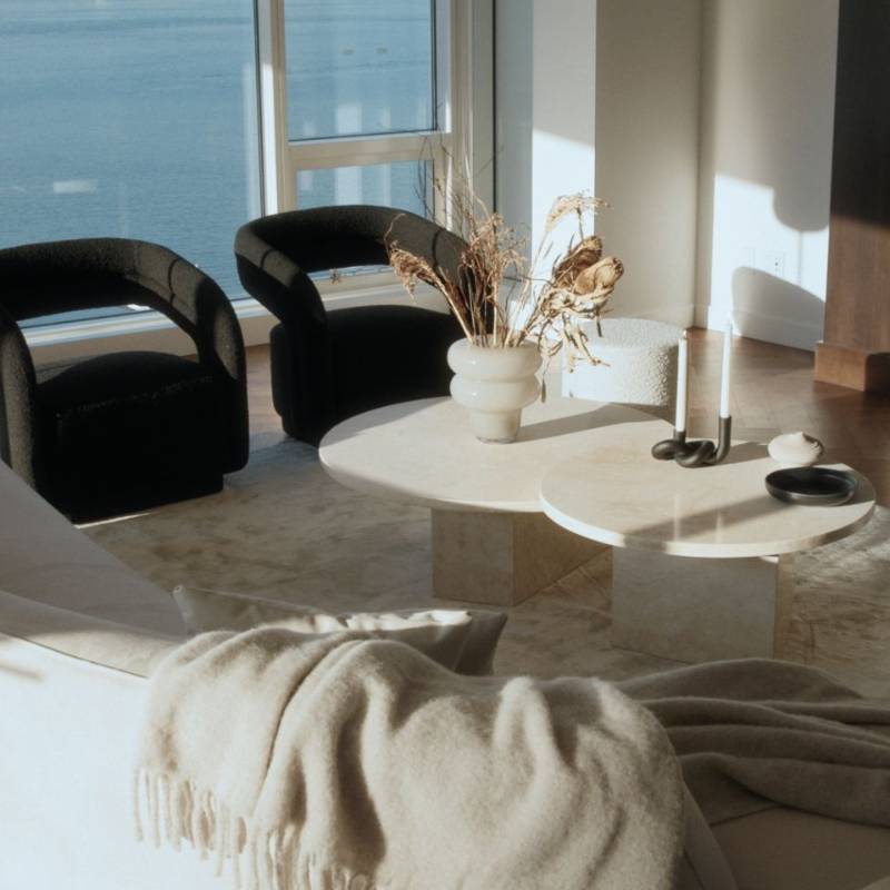The Romulus Nesting Coffee Table in White Travertine in a Living Room