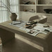 Angled View of The Cascadia Desk in Alabaster Concrete in Front of a Bookcase in an Office