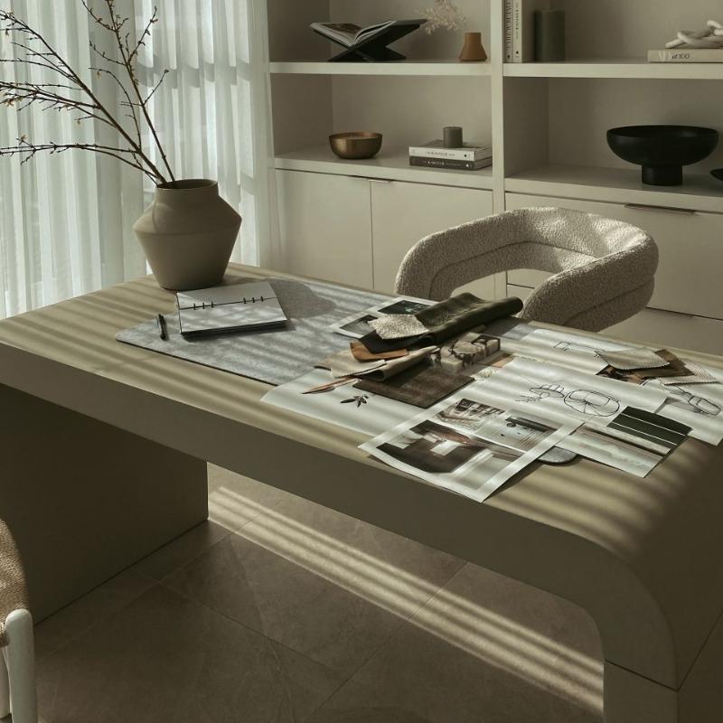 Angled View of The Cascadia Desk in Alabaster Concrete in Front of a Bookcase in an Office