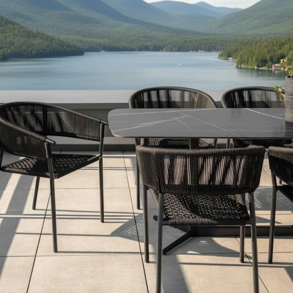 Close Up View of The Elaine Dining Table With Black Pietra Ceramic Surface and Black Base on a Patio