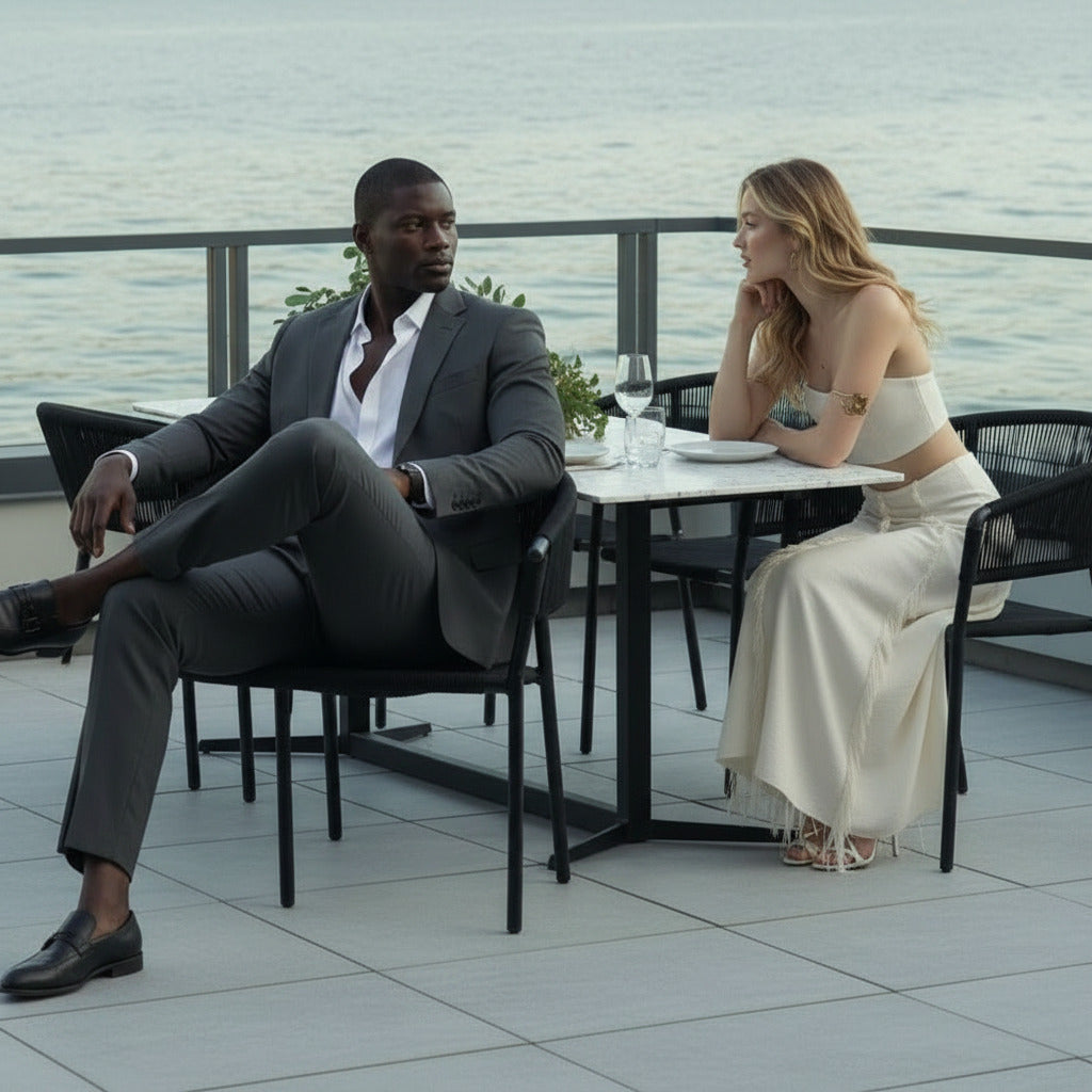 Couple Next to The Elaine Dining Table With Black Pietra Ceramic Surface and Black Base