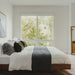 Side Facing View of a Mikkel Bed With Alesund Fabric in a Small Bedroom Next to a Window