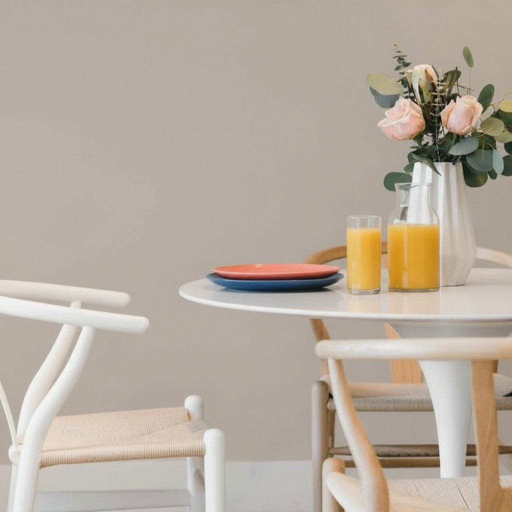 Close Up View of The Tulip Table Round With White Carrara Marble Surface and White Base With Table Setting