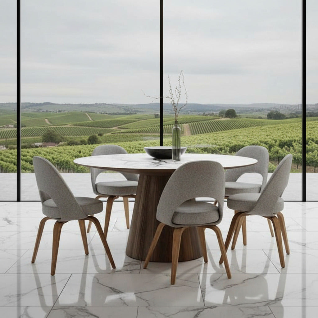 Front Facing View of The Winston Dining Table 63 inch in White Calacatta Ceramic Surface and Walnut Veneer Base in Dining Room Next to Large Window