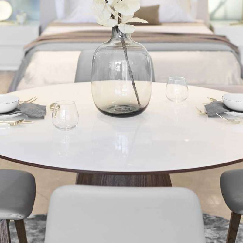 Close Up View of The Winston Dining Table 48 Inch With High Gloss White Lacquer Surface and Walnut Veneer Finish With Place Settings