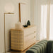 The Wishbone Dresser in a Corner of a Room Next to a Window